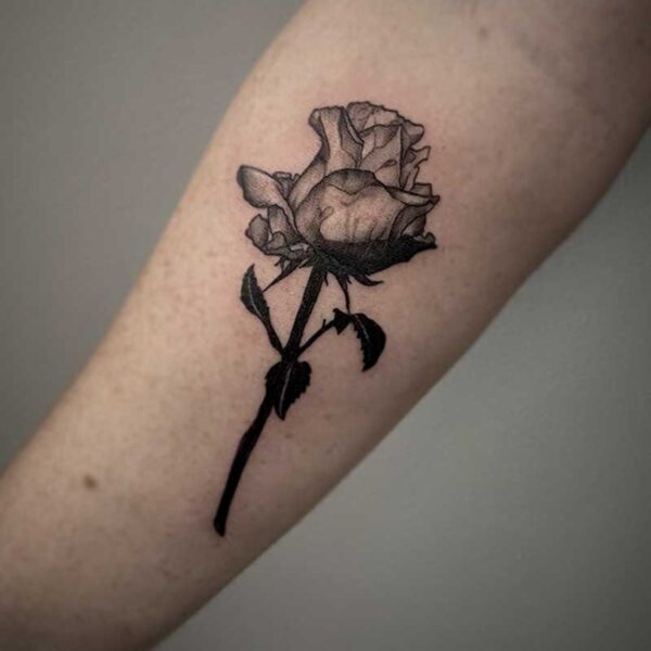 black and white realistic tattoo of a rose