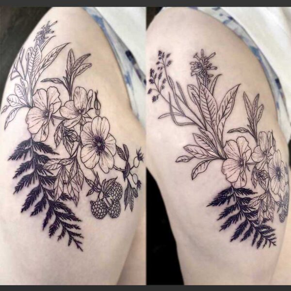 black and white tattoo of flowers and fauna