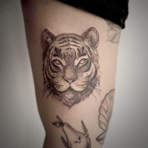 black and white tattoo of a tiger's face