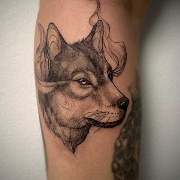 black and white tattoo of a wolfs face