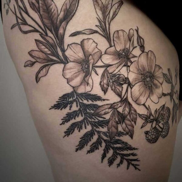 black and grey tattoo of flowers, berries and foliage