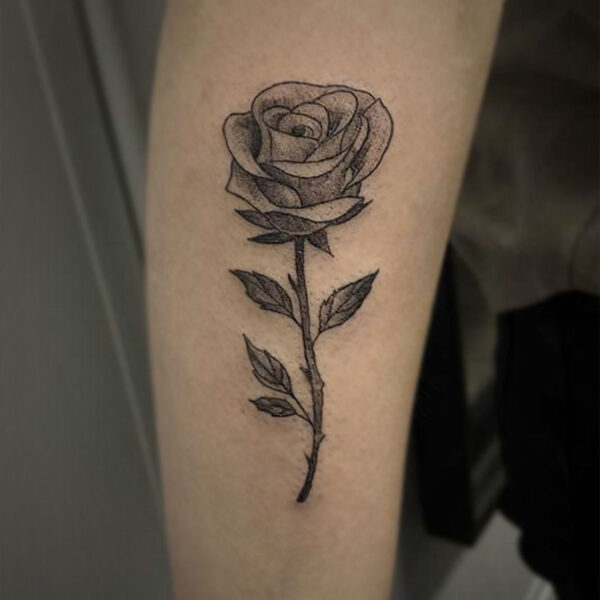 black and grey tattoo of a rose