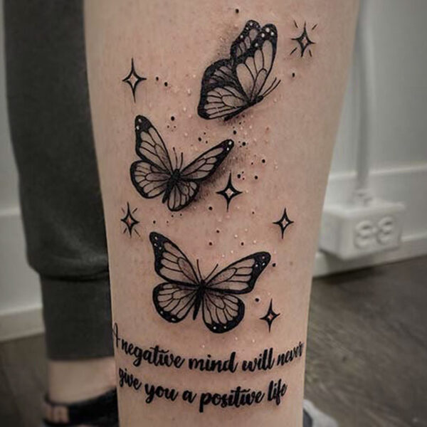 black and grey tattoo of three butterflies and sparkles