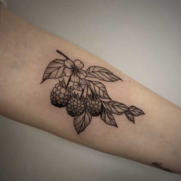 black and grey tattoo of blackberries and foliage