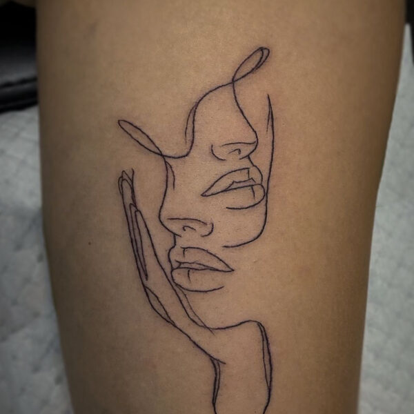 outline tattoo of two women's faces