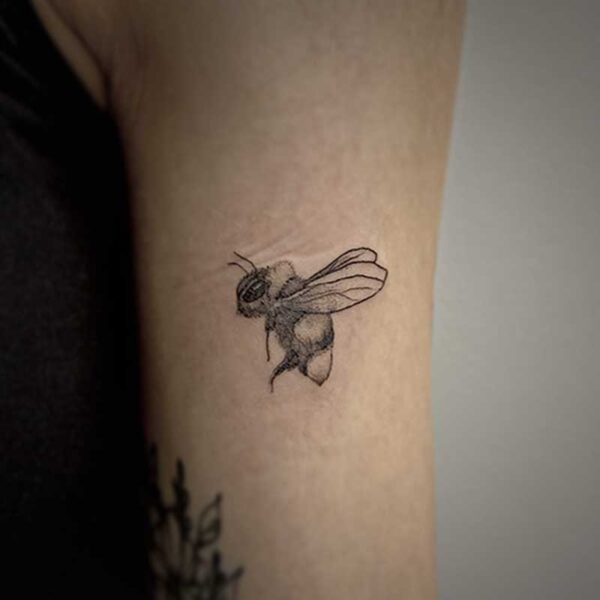 black and white tattoo of a bee