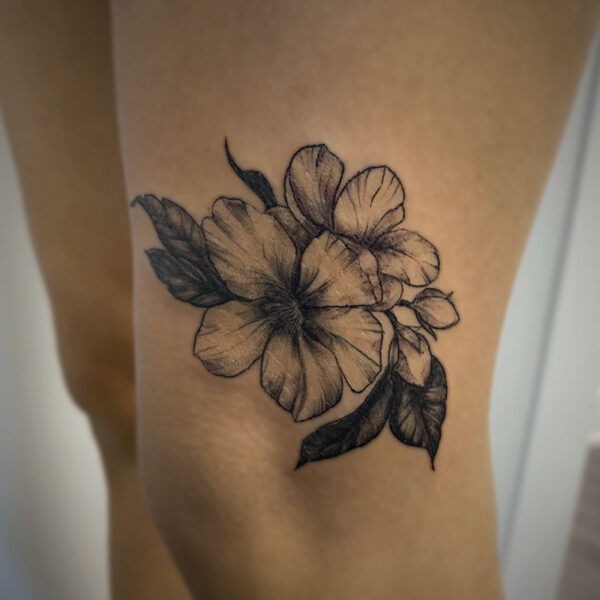 black and grey tattoo of flowers