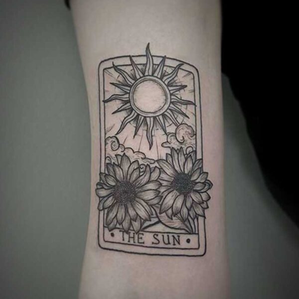 black and white tattoo of a tarot card for the sun with sunflowers