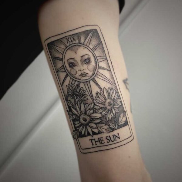 black and white tattoo of a tarot card of the sun with sunflowers