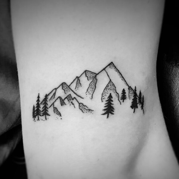 black outline tattoo of a mountain range