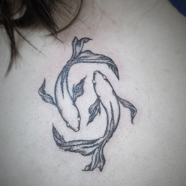 black and white tattoo of two beta fish