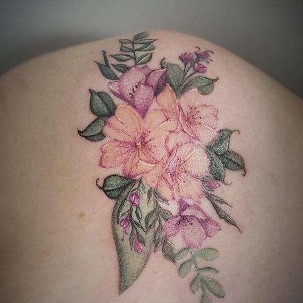 coloured tattoo of flowers and greenery