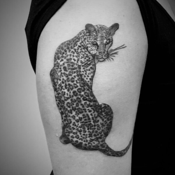 black and white tattoo of a spotted jaguar