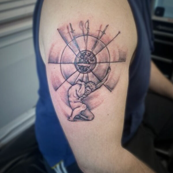 atticus tattoo, black and white tattoo of a man crouching and holding up a ring of swords