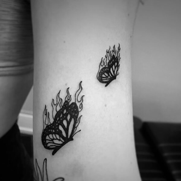 black and white tattoo of butterflies with flames