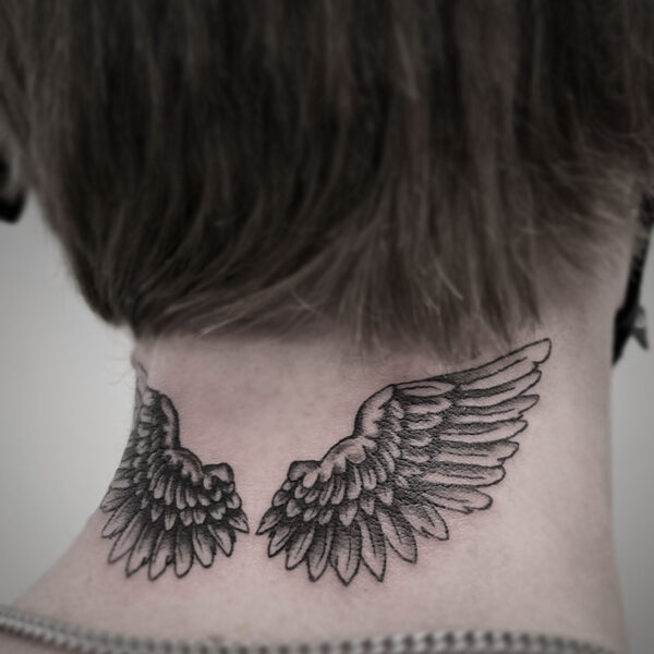 black and white tattoo of angel wings