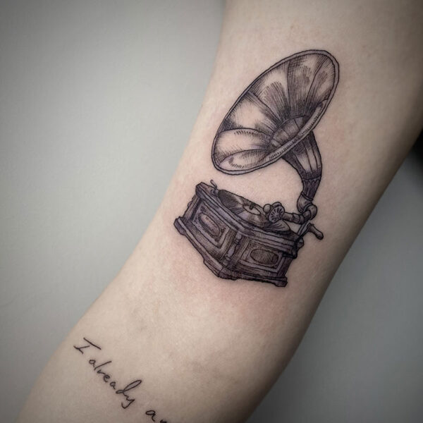 black line tattoo of a gramophone record player