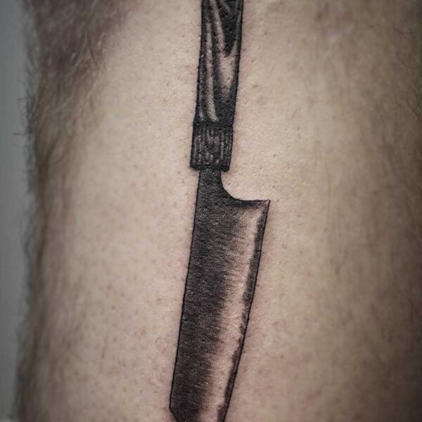 black and white tattoo of a butchers knife