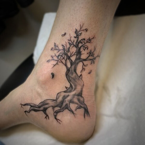 atticus tattoo, black and white tattoo of a tree with falling leaves