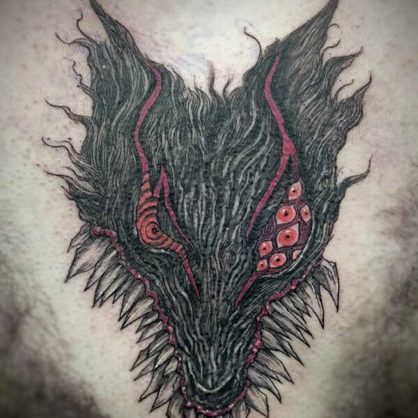 atticus tattoo, black and white tattoo of monster wolf's head with several red eyes