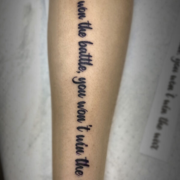 black text tattoo of the words "you won the battle, you won't win the war"