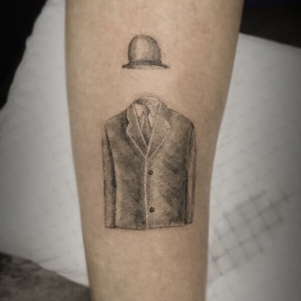 atticus tattoo, black and grey tattoo of an invisble man wearing a suit jacket and bowler hat