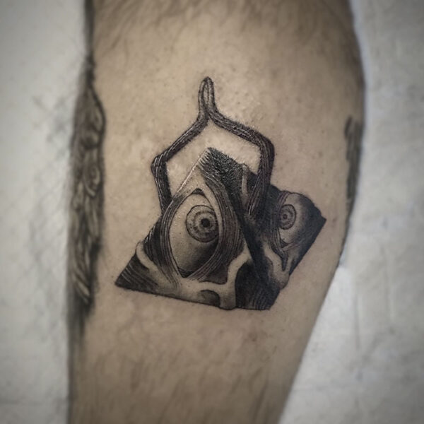 atticus tattoo, black and grey tattoo of a monster in the shape of a pyramid with arms and eyes