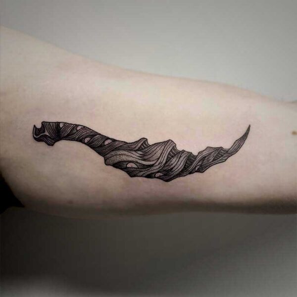 atticus tattoo, black and grey tattoo of a monster in the shape of a dagger