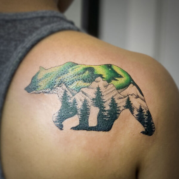 atticus tattoo, tattoo of a bear silhouette with a mountain range and the Northern lights