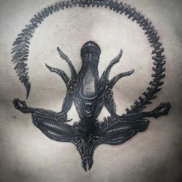 atticus tattoo, black and grey tattoo of a xenomorph in a meditation pose