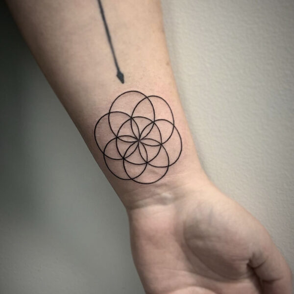 atticus tattoo, fine line tattoo of several circles that are linked