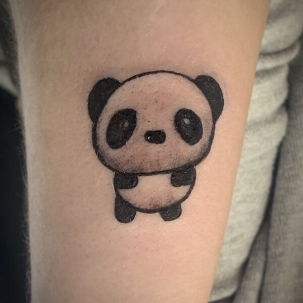atticus tattoo, black and grey tattoo of a cartoon panda