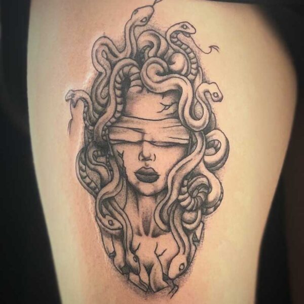 atticus tattoo, black and grey tattoo of medusa wearing a blindfold