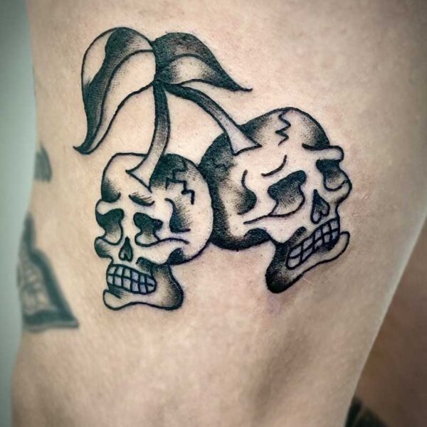 atticus tattoo, black and white american traditional style tattoo of cherry skulls