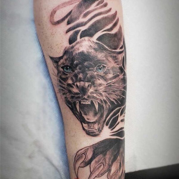 atticus tattoo, black and grey tattoo of a panther with blue eyes