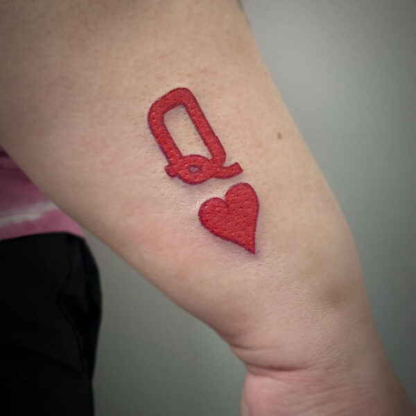 atticus tattoo, red tattoo of a Q and heart
