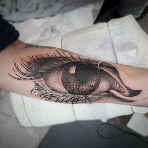 atticus tattoo, black and grey realism tattoo of a woman's eye