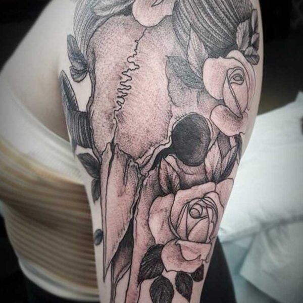 atticus tattoo, black and grey tattoo of a ram skull and roses