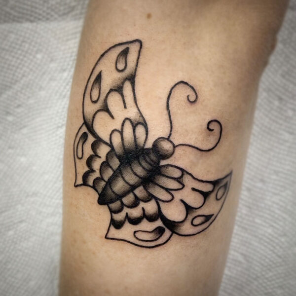 atticus tattoo, black and grey american traditional style tattoo of a butterfly