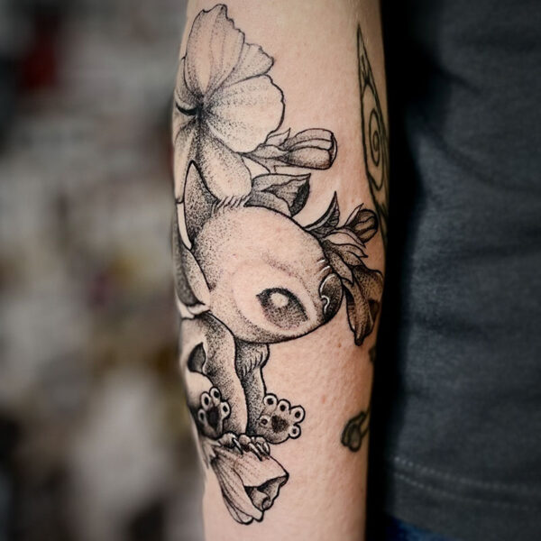atticus tattoo, black and grey tattoo of Stitch and flowers