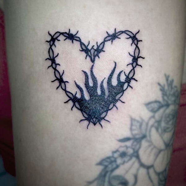 black tattoo of a barbed wire hear with flames