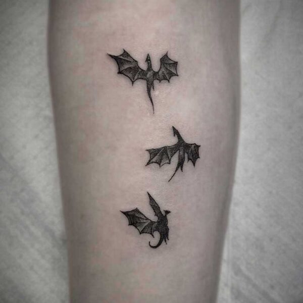 atticus tattoo, black and white tattoo of three small dragons