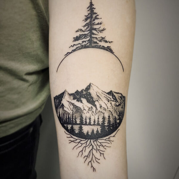 black and white tattoo of a pine tree framing a mountain scene
