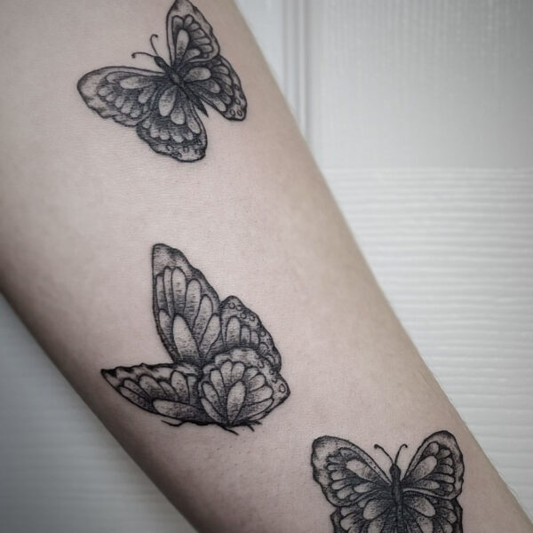 realistic black and white tattoos of three butterflies