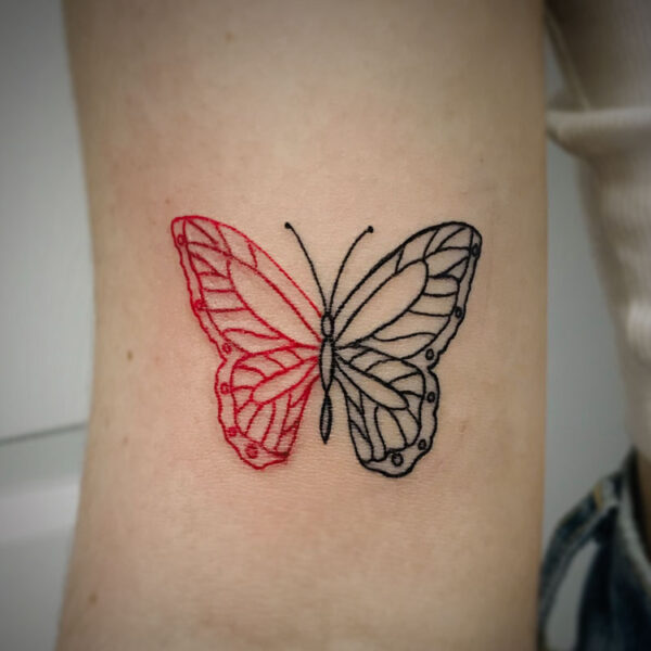 half red and half black butterfly tattoo