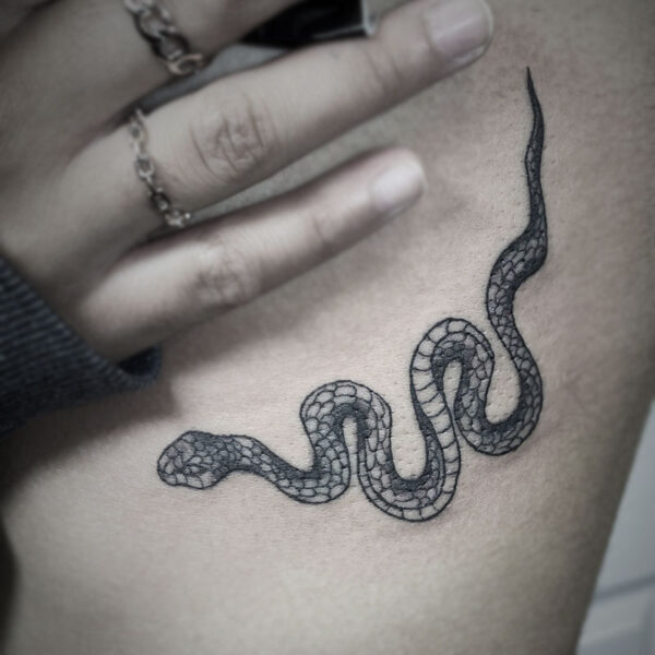 black and white tattoo of a snake