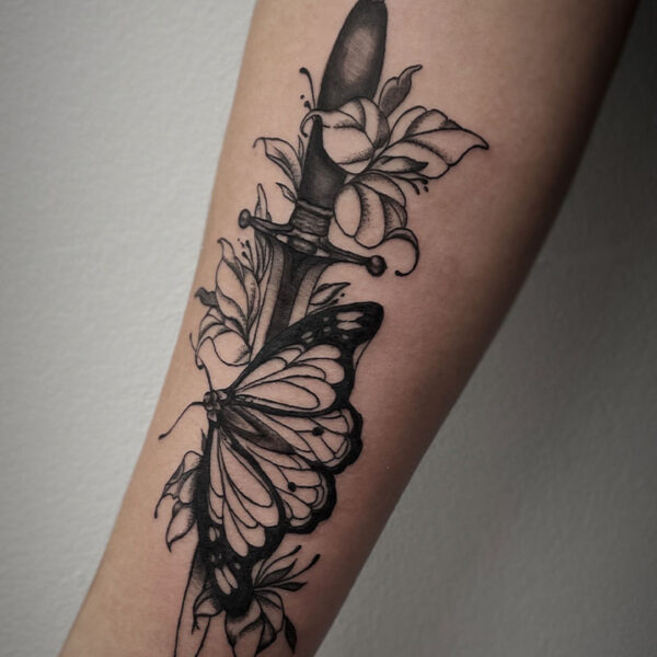 realistic black and white tattoo of a dagger, butterfly and flowers