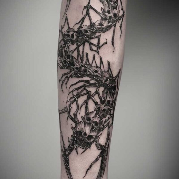 atticus tattoo, black and white tattoo of a monster centipede