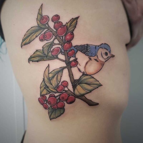 atticus tattoo, coloured tattoo of a blue bird sitting on a branch of red berries