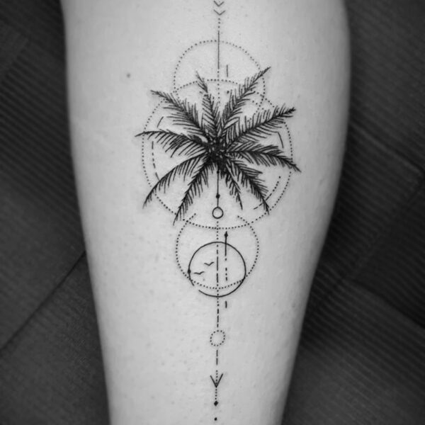 fine line tattoo of palm leaves and circles